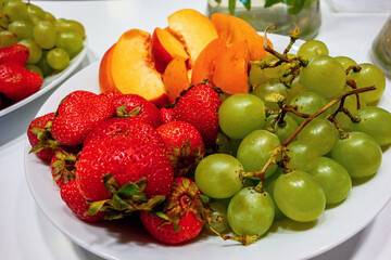 Plate with strawberry,grape,apricot and peach.