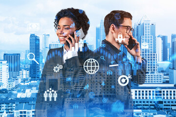 Two colleagues in multinational corporate team processing call new tech approaches to solve problems at research and development department. Fintech hologram icons over Kuala Lumpur