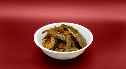 Homemade Mango Pickle or Aam ka Achar isolated on black background.