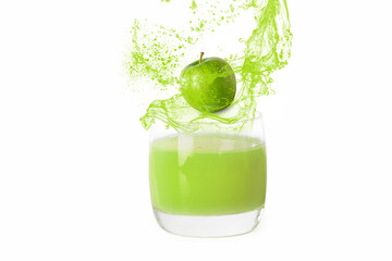 splashing apple juice with fresh apple in a glass against white background, isolated