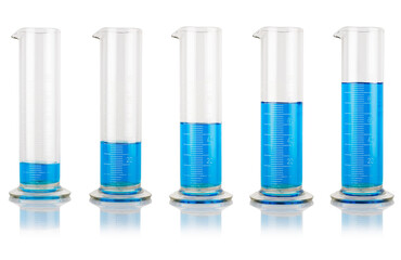 Five glass beakers filled with clear blue liquid. Laboratory concept. 