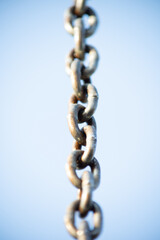 Strong metal chain against the blue sky