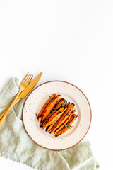 Sweet potato fries with spices on a wooden board, top view