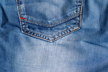 Blue jeans fabric texture. Distressed denim with back pocket background