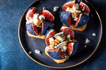 Appetizer with figs and blue cheese. salted cracker. Cheese with honey. Snack and antipasto. Dorblu cheese.