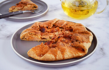 Quince galette with fresh quince. Traditional rustic fruit homemade pie, top view.