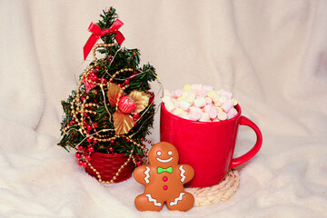 Obraz na płótnie Canvas Red Cup Of Hot Chocolate With Marshmallow with Gingerbread man Cookie and New year tree On White Background.