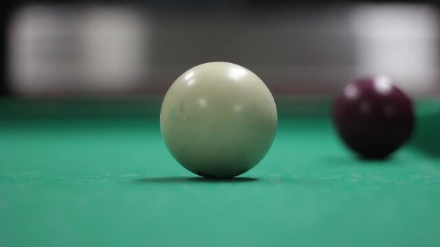 Billiard balls on the table. Game of billiards. Table covered with green cloth. White balls.