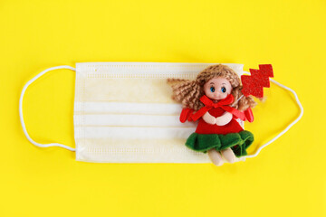 white medical face mask and a Christmas toy doll