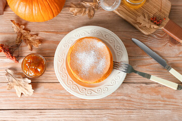 Tasty pumpkin pancakes on table
