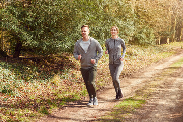 Fototapeta premium Couple Exercising In Autumn Countryside During Covid 19 Lockdown