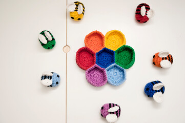 Colorful beehive with bees. Crochet safe toys for babies. Processed egg craft ideas are a bright Easter-colored rainbow-colored educational toy. Preschool game for young children. Montessori education