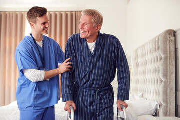 Obraz premium Male Doctor Making Home Visit To Senior Man With Walking Frame For Medical Check In Bedroom