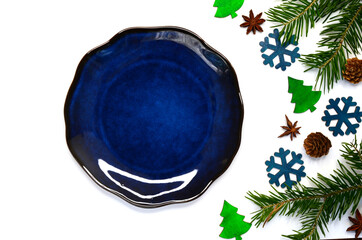 clay plate with christmas decor and anise top view isolated on a white background