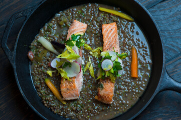 Salmon steaks. Salmon sautéed in organic butter, garlic and served with jumbo lump crab cake, cauliflower, broccoli and potatoes. Classic American restaurant or French bistro entree favorite.