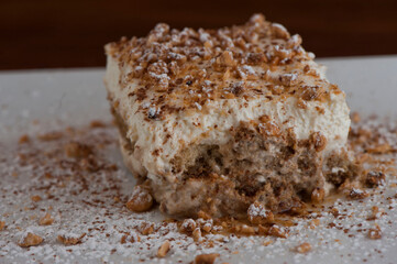 Tiramisu Dessert. Classic Italian dessert. Lady fingers soaked in syrup, espresso and layered with cream, nuts and powdered sugar.