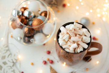 Fototapeta na wymiar Christmas hot chocolate with marshmallow and gingerbread cookies on white wooden table. Traditional hot drink at Christmas.