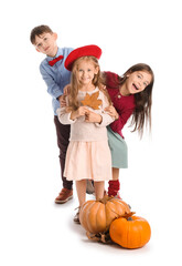 Cute little children in autumn clothes and with pumpkins on white background