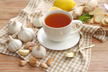 Fototapeta na wymiar Cup of healthy garlic tea on table