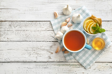 Fototapeta na wymiar Cup of healthy garlic tea on table