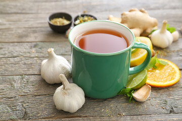 Cup of healthy garlic tea on table