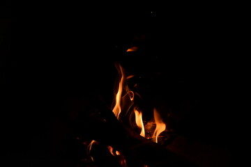 Fototapeta premium Warm fire and sparks in a fire-place from conflagrant wooden logs
