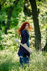 cosplay Brave red curly girl with a bow in the woods