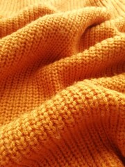 
knitted orange background from sweater fabric