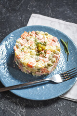 Russian traditional salad Olivier with vegetables and meat.