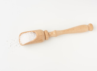 large crystals of white sea salt in a brown wooden spoon