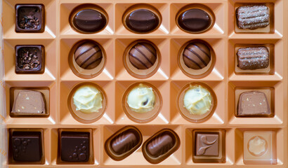 Box of milk and dark chocolates with one missing