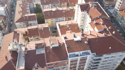 Aerial view of city building roofs at the sunset