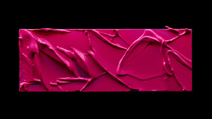 Swatch of pink lipstick isolated on black background