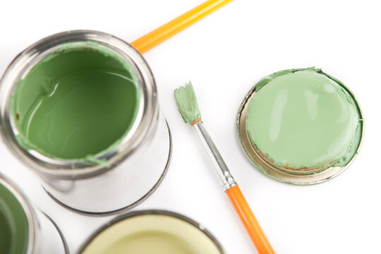 Cans And Brushes With Different Shades Of Green House Paint.
