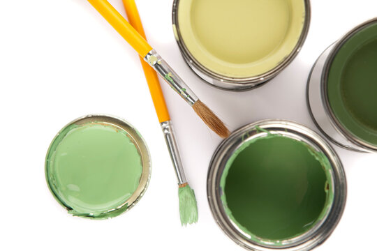 Cans And Brushes With Different Shades Of Green House Paint.