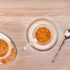 Making coffee. Granules of instant coffee in glass cup. Top view.