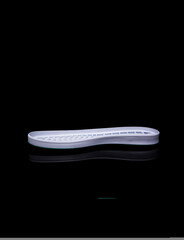 white shoe sole. Isolated on a black background.