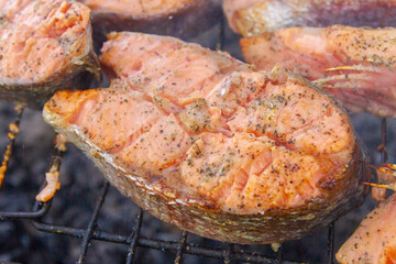 Large fish steaks fresh trout fried in spices on the grill