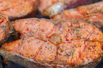Large fish steaks fresh trout fried in spices on the grill