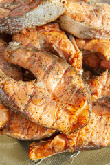 Grilled red fish trout steaks lie on a glass plate