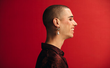 Androgynous man wearing earring and makeup