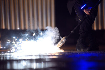Fire juggler hand lighting the torch on from the bowl during fire show