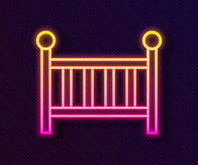 Glowing neon line Baby crib cradle bed icon isolated on black background. Vector.
