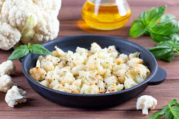 Baked cauliflower with herbs and spices. Vegetarian vegan food
