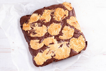 Brookies — Half brownie, half cookie dough bar cookie sliced by squares on parchment paper