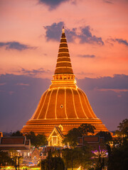 Large golden pagoda Located in the community at sunset , Phra Pathom Chedi , Nakhon Pathom province, Thailand. This is  public property, no restrict in copy or use.