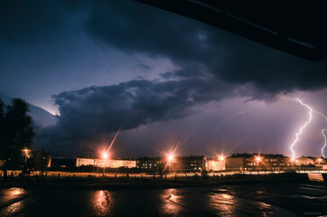 Naklejka na ściany i meble thunderstorm in the city at night