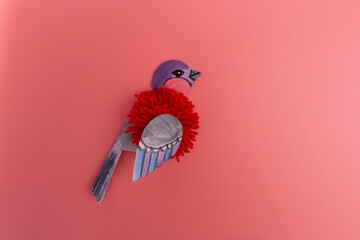 Paper cut bullfinch bird craft for children on pink background, Winter holiday home decoration,...