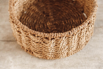 Fototapeta premium Empty round wicker basket on a old wooden background. Top view. Copy, empty space for text