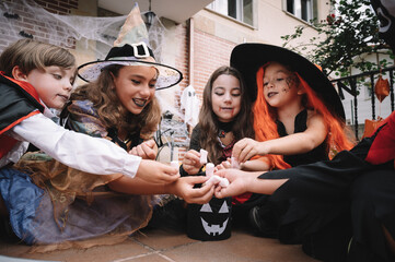 Children sharing and comparing their candies on halloween